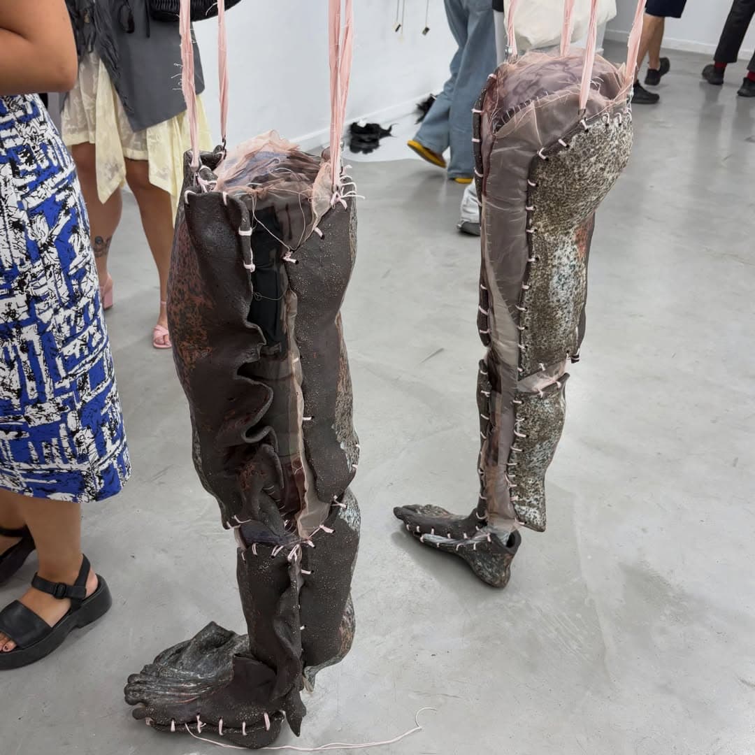 Stitched ceramic legs on a gallery floor